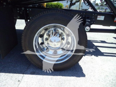 Truck wheel and chassis showing chrome wheel with tire; no other readable text visible on image.