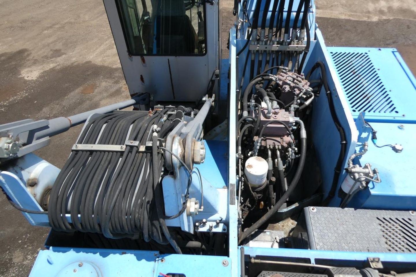 Terex MHL350D mast crane/loader upper view showing hydraulic hoses, control lever cluster, and engine area.