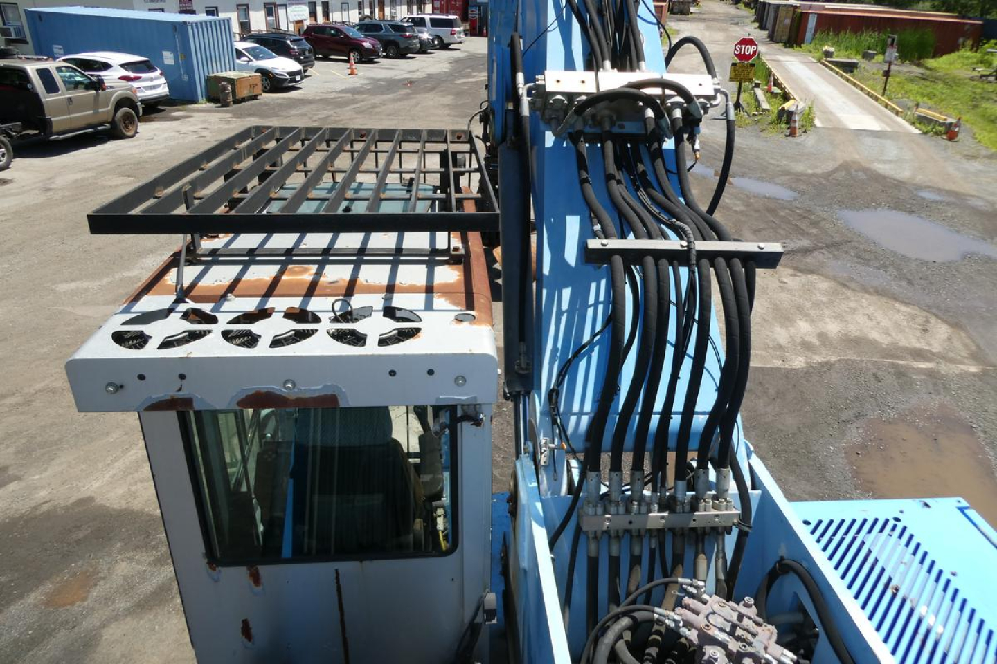 Terex MHL350D equipment view showing hydraulic lines and operator cab with metal storage rack.