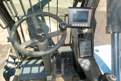 Cab interior of Terex MHL350D showing steering wheel, foot pedals, and dashboard with monitor and keypad.