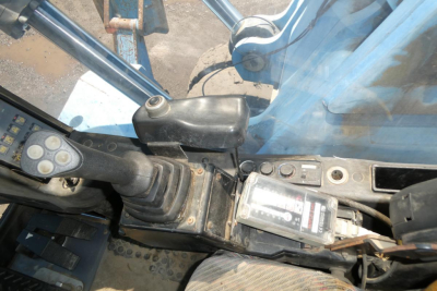 Terex MHL350D operator cab control lever and joystick with display panel and hydraulic levers inside cab.