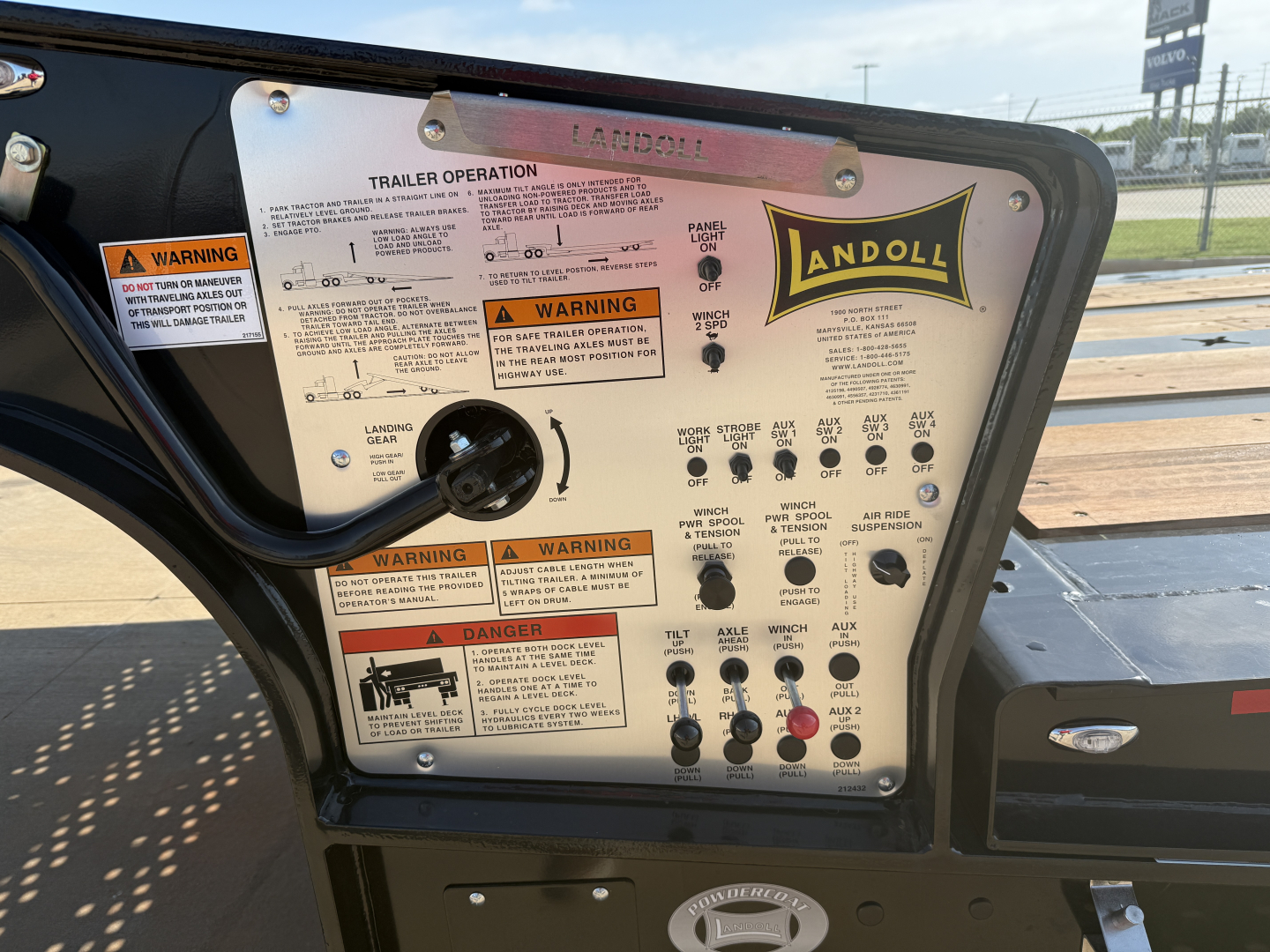 Landoll 455B-53 trailer control panel with labels, warning decals, and switches visible inside rear door area.