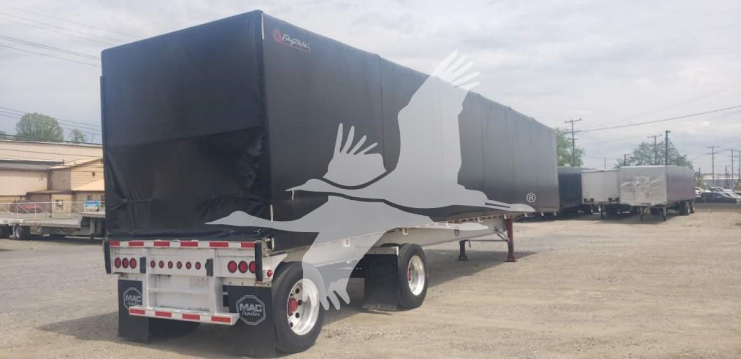 Curtainside trailer in in-service condition showing rear and side with black tarpaulin cover.