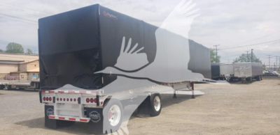 Trailer side and rear showing curtainside Mac 72K beam trailer with black tarp covers, white wheels, and rear doors; stock tag and VIN visible.