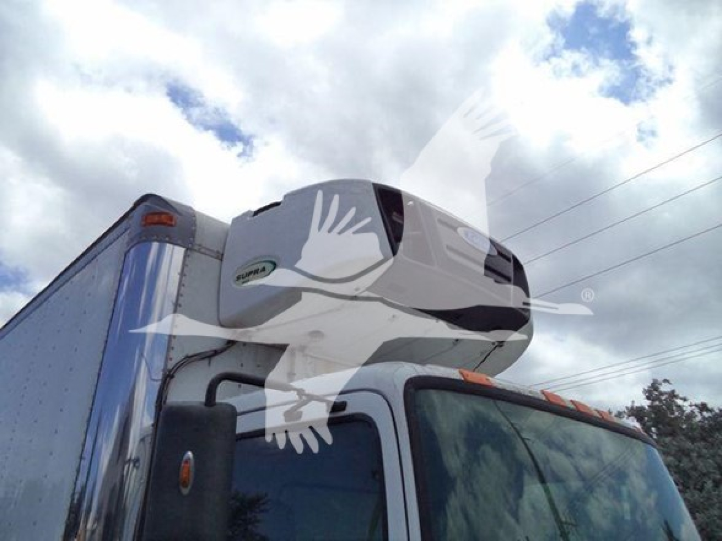 Hino 268a refrigerated truck cab with trailer unit on top, side view, no visible text.