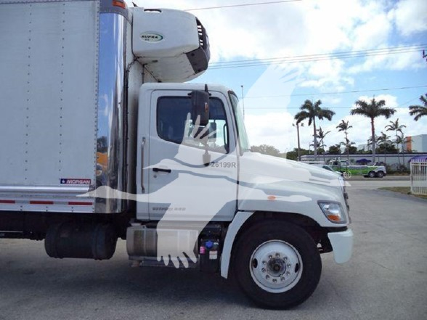 Truck cab of a 2019 Hino 268a refrigerated truck showing front-left view with refrigerated cargo unit and VIN sticker.