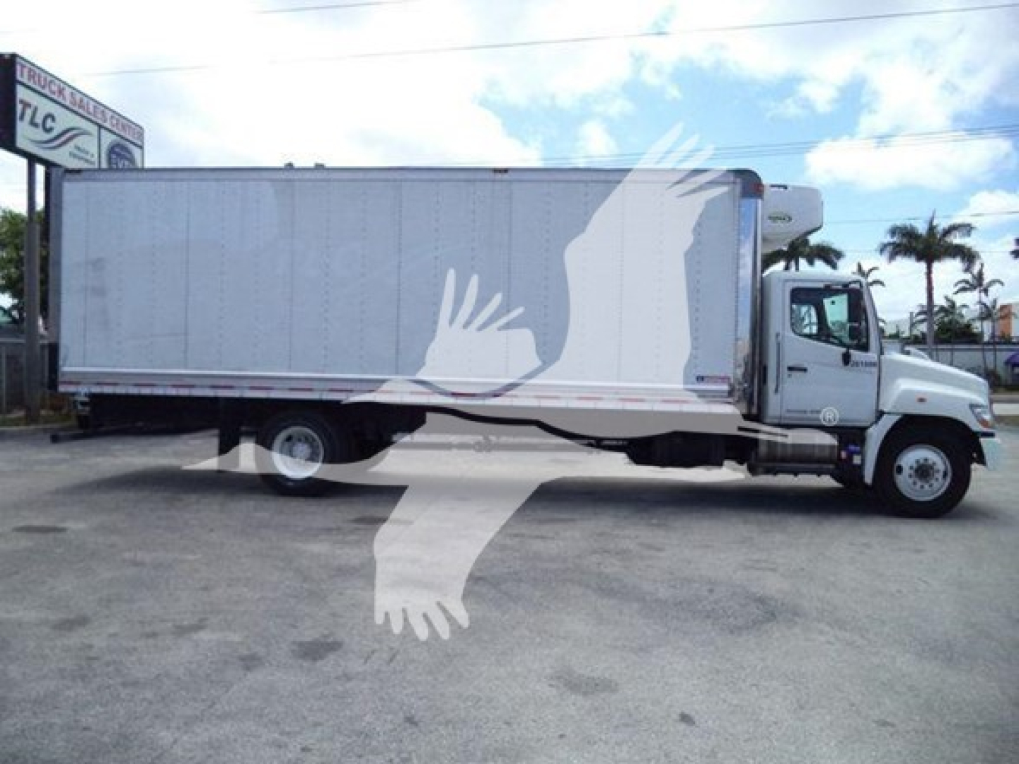 Refrigerated truck side view showing cargo box and cab of a 2019 Hino 268a with stock number 26199R and VIN 5PVNJ8JV0K4S73415