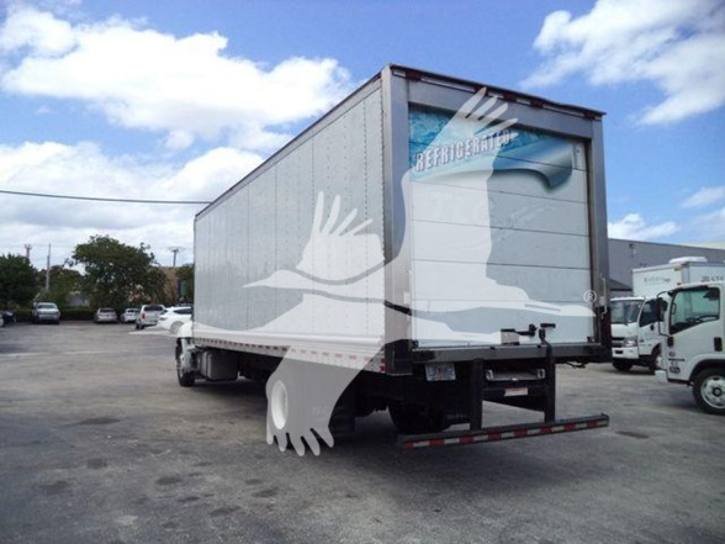 Refrigerated truck trailer showing rear view with ramp and Hino branding on back door.