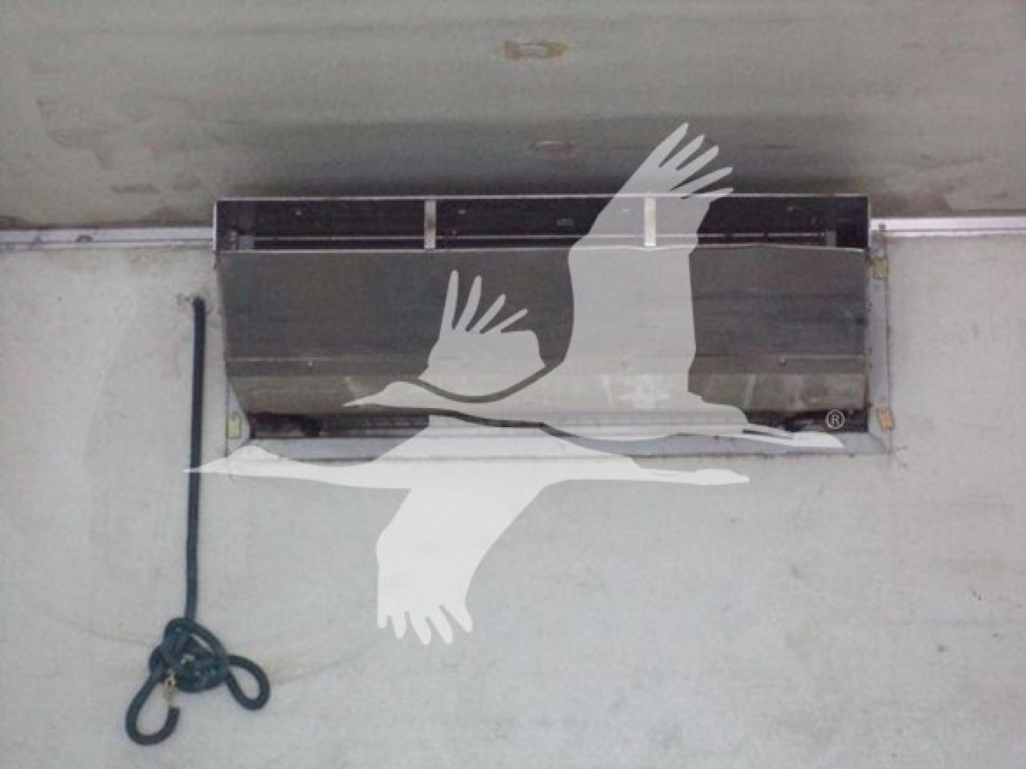 Refrigerated truck interior ceiling with airflow vent and hanging cord, showing a large vent opening.