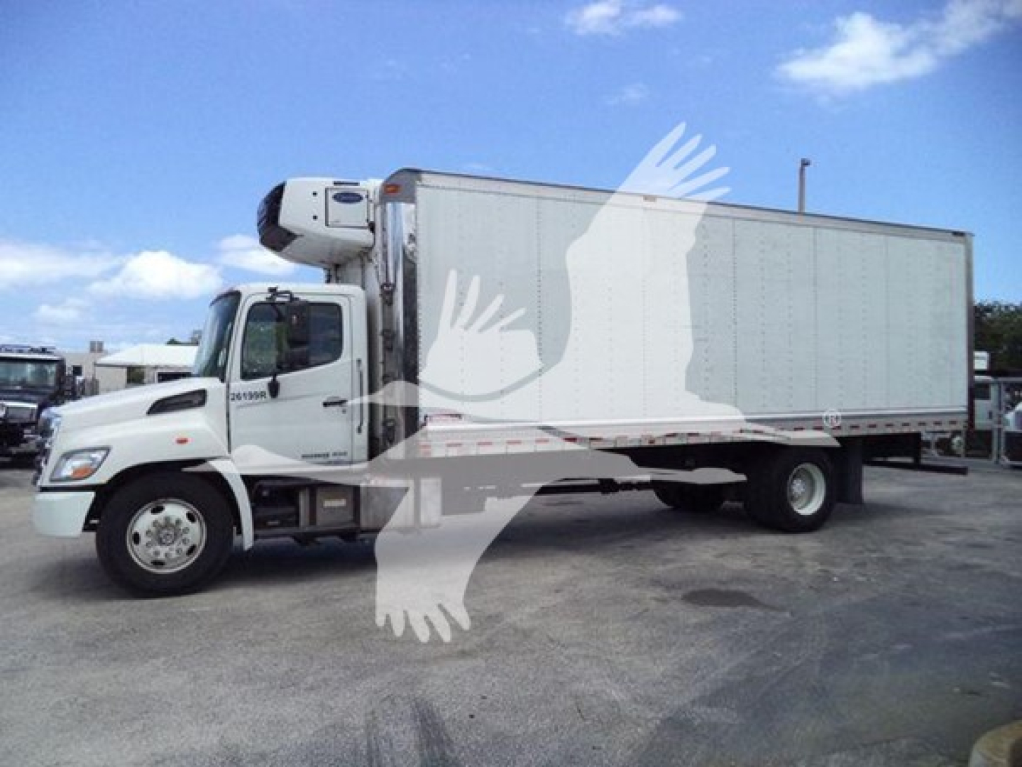 Hino 268a refrigerated truck in-service showing box truck with reefer unit on cab roof and VIN/stock text visible