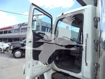 Truck cab with open door showing interior of a 2019 Hino 268a refrigerated truck, matching the listing text with VIN 5PVNJ8JV0K4S73415 and stock 26199R.
