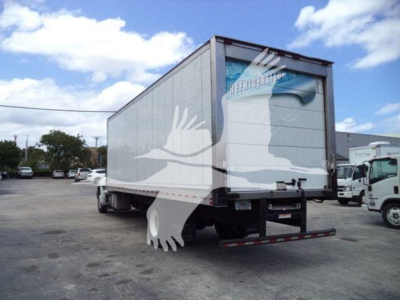 Refrigerated truck trailer showing rear view with ramp and Hino branding on back door.