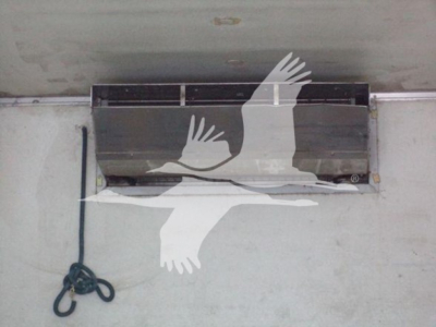 Refrigerated truck interior ceiling with airflow vent and hanging cord, showing a large vent opening.