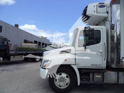 Hino 268a commercial truck cab in side view with refrigerated box, white exterior, VIN 5PVNJ8JV0K4S73415 visible on door.
