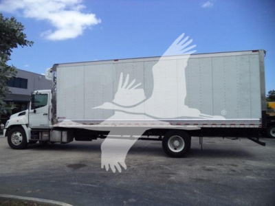 Truck side view of a 2019 Hino 268a refrigerated box truck with white cab and gray box.