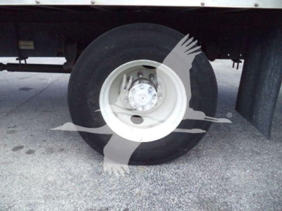 Hino 268a refrigerated truck wheel and tire showing white steel wheel, dual rear axle area, undercarriage components visible.
