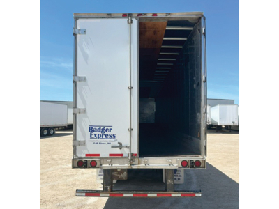 Rear view of a white trailer with open doors showing interior. Badger Express logo visible on left door and a red/blue stripe near the bottom.