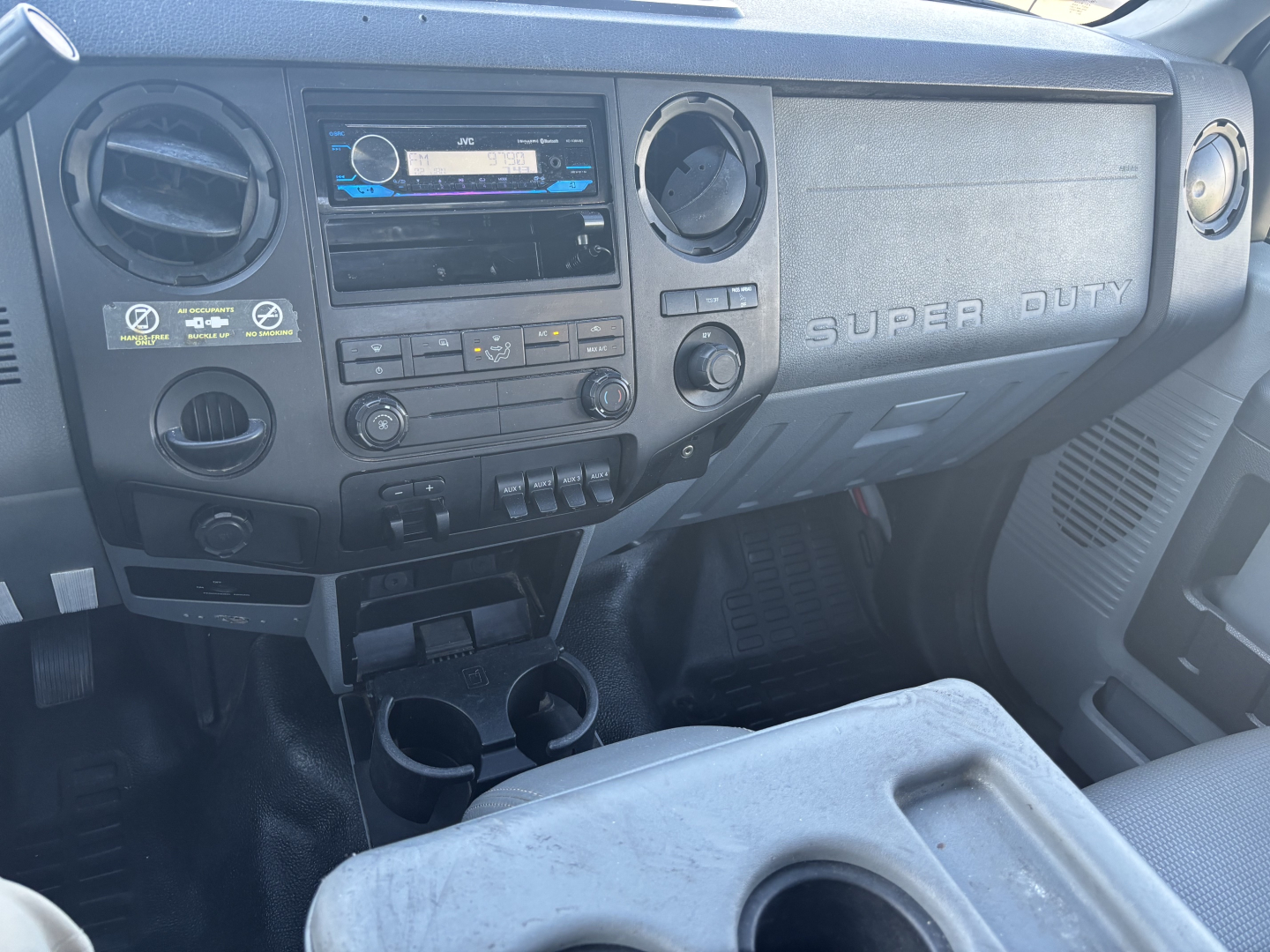 Ford F-550 Super Duty dashboard and center console with cup holders, radio, and climate controls visible.
