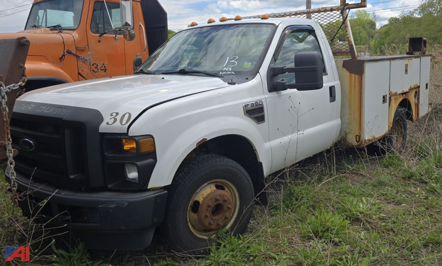 Ford F-350 Super Duty utility box truck, white cab, rusty service body, visible front grille and single rear wheel, with numbers 30 on hood and 13 on windshield.