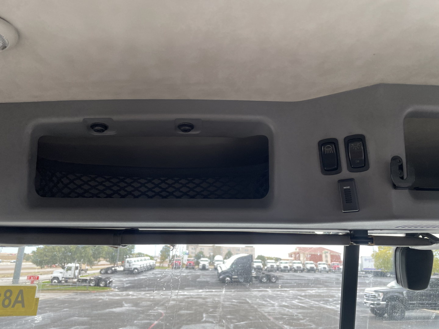 Cab interior overhead panel showing storage pocket and control switches in Mack AN64T truck cab