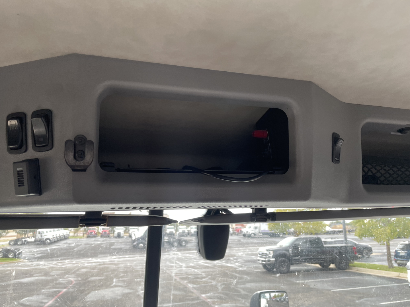 Mack AN64T dash area showing empty rectangular storage cavity and wiring inside cabin area.