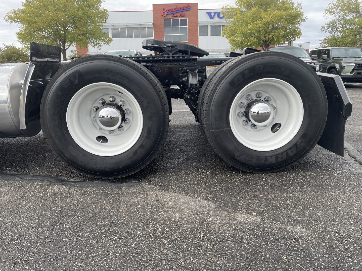 Mack AN64T truck rear dual axles showing dual tires and wheel rims with center hub caps.