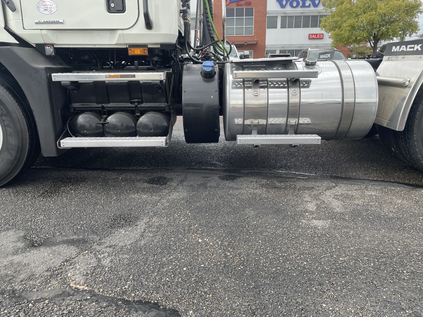 Truck side view showing fuel tanks and undercarriage of a Mack AN64T conventional daycab.