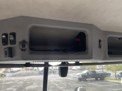 Mack AN64T dash area showing empty rectangular storage cavity and wiring inside cabin area.