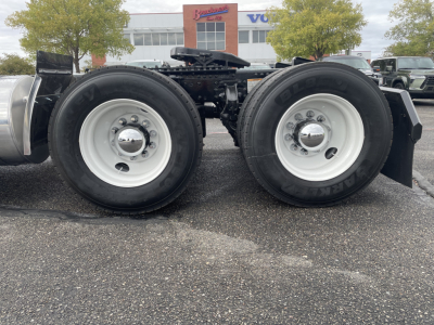 Mack AN64T truck rear dual axles showing dual tires and wheel rims with center hub caps.