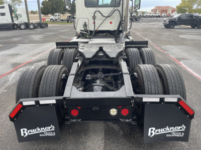 Rear view of a 2021 Mack AN64T daycab truck chassis showing dual rear axle with six tires and mudflaps labeled Bruckner's Truck & Equipment.