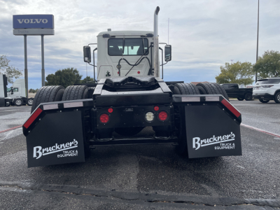 Rear view of a 2021 Mack AN64T daycab truck showing dual rear fenders with Bruckner's Truck & Equipment branding, brake lights, and towing hitch area.