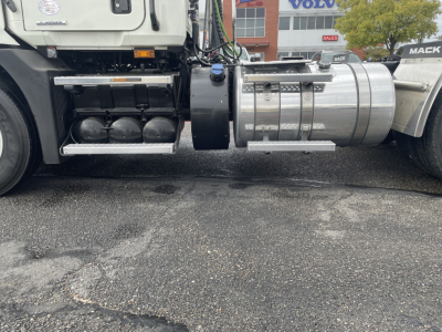 Truck side view showing fuel tanks and undercarriage of a Mack AN64T conventional daycab.