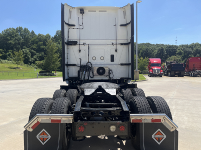 Rear view of a 2021 International LT625 tractor showing dual rear axles, fifth-wheel area, and rear mud flaps with reflective chevron decals.
