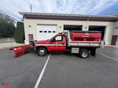 Ford F-350 Super Duty dump truck with plow and sander, red body, white building in background, plow at front and sander bed behind cab.