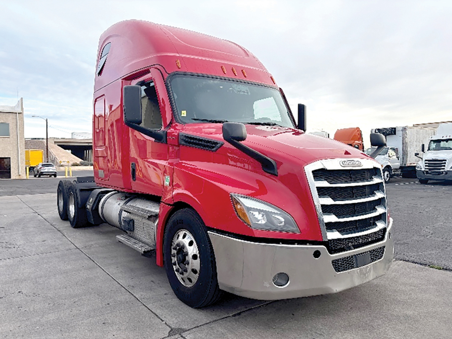 Freightliner Cascadia126 sleeper cab truck in red, front-right view, showing chrome grille, large bumper, dual exhaust, and sleeper cab behind cabin.