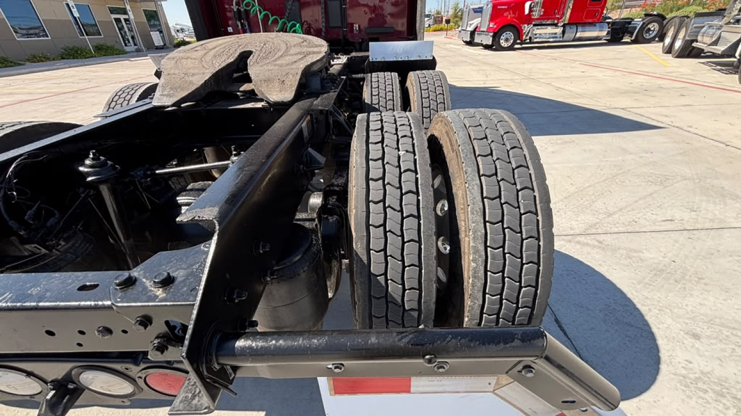 Kenworth T680 chassis with dual rear tires and frame showing undercarriage components.