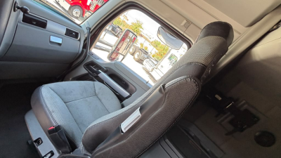 Cab interior of a 2022 Kenworth T680 truck showing driver seat and dashboard area