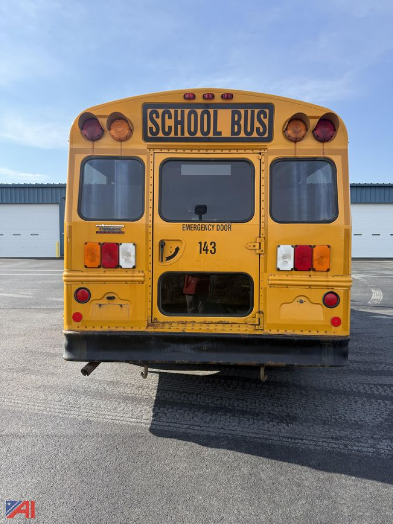 Rear view of a yellow 2014 Chevrolet Express G3500 mini school bus showing school bus sign, rear doors, tail lights, and emergency exit lettering.