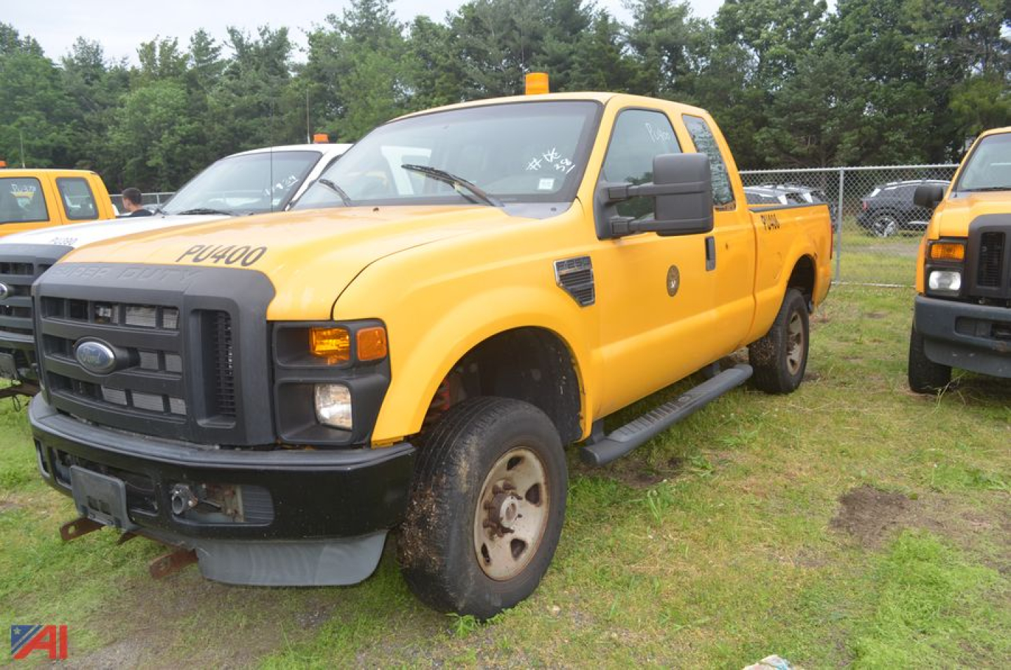 Ford F-250 Super Duty pickup truck extended cab, yellow, front-left view showing Ford grille and black bumper, 4x4, service-style, used condition.