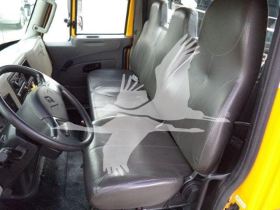 Cab interior of a 2019 International Durastar 4300 with grey vinyl seats, steering wheel, and front door; no visible text on components.