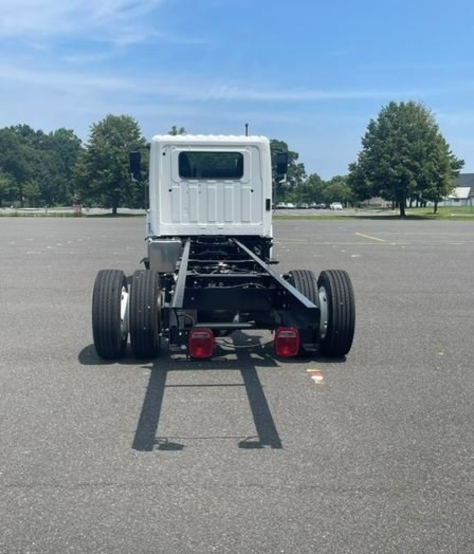 Rear view of a new Hino L6 box van truck chassis showing dual rear axles and tail lamps.