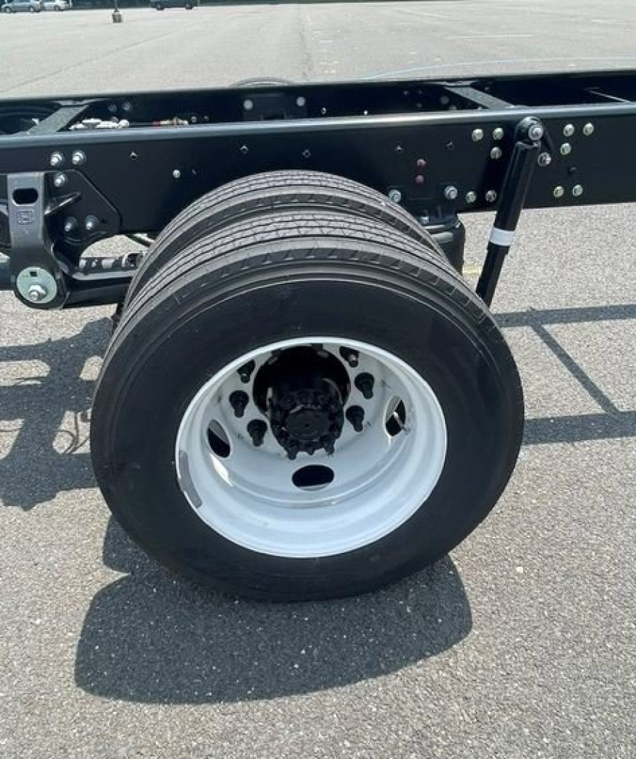 Hino L6 truck chassis showing wheel and suspension with black undercarriage and white rim.
