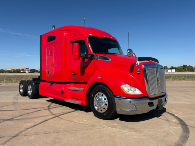 Kenworth T680 sleeper cab tractor in red, front three-quarter view showing chrome bumper, dual rear axles, and large grille.