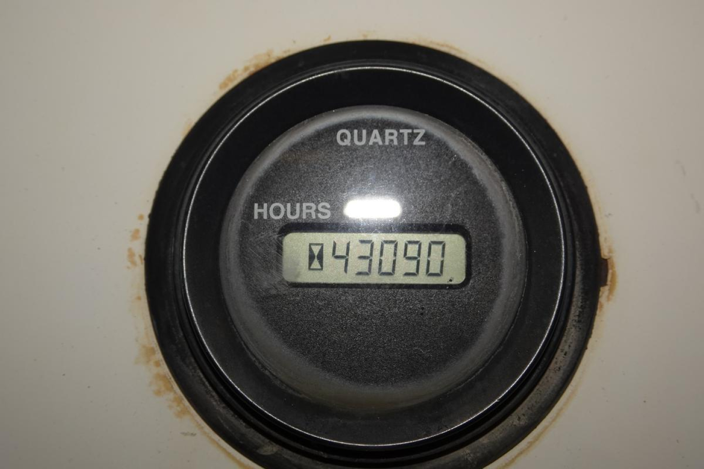 Quartz hour meter reading 43090 hours in a black circular gauge on a Kalmar Ottawa YT50 yard truck instrument panel.