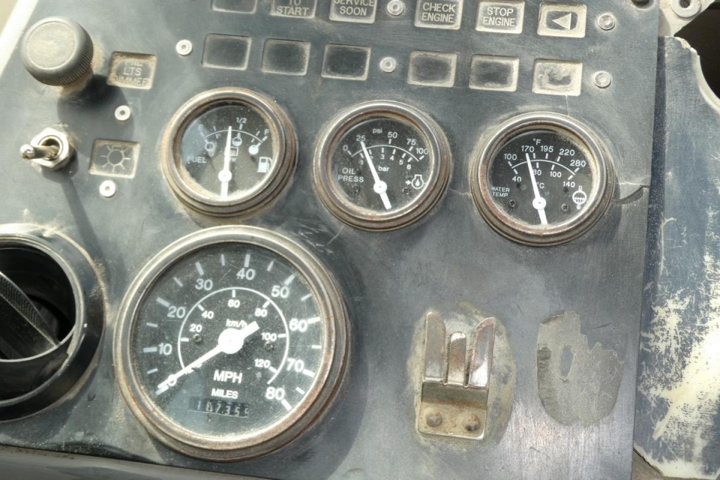 Instrumentation panel of a Kalmar Ottawa YT50 truck showing round gauges including speedometer, tachometer, and auxiliary dials with worn dashboard edges.