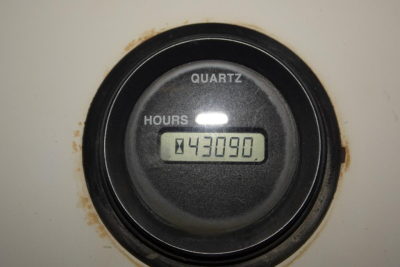Quartz hour meter reading 43090 hours in a black circular gauge on a Kalmar Ottawa YT50 yard truck instrument panel.