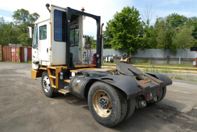 Truck tractor chassis and cabin of a Kalmar Ottawa YT50 yard truck showing rear coupling and exposed fuel tank.