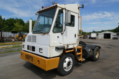 Front-left view of a white and yellow Kalmar Ottawa YT50 yard truck tractor in a used equipment lot.