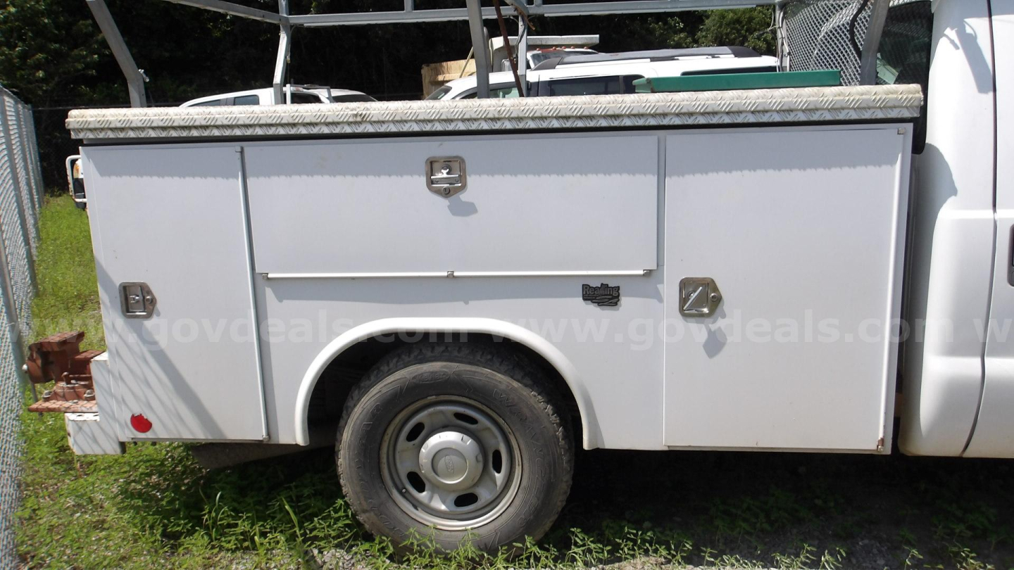 Ford F-250 service body side view showing utility compartments and single rear wheel.