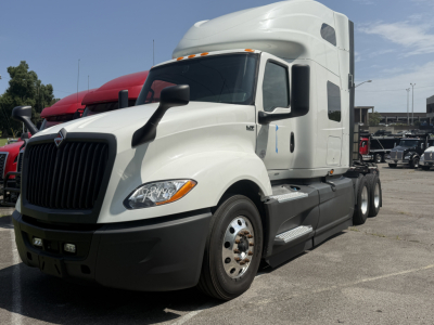 Truck cab of a white 2021 International LT625 semi-truck in a lot.
